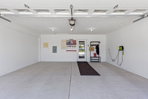 A white room with a black mat on the floor.