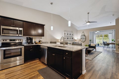a large kitchen with stainless steel appliances and a counter top