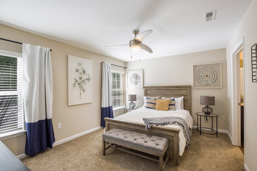 a bedroom with a large bed and a ceiling fan