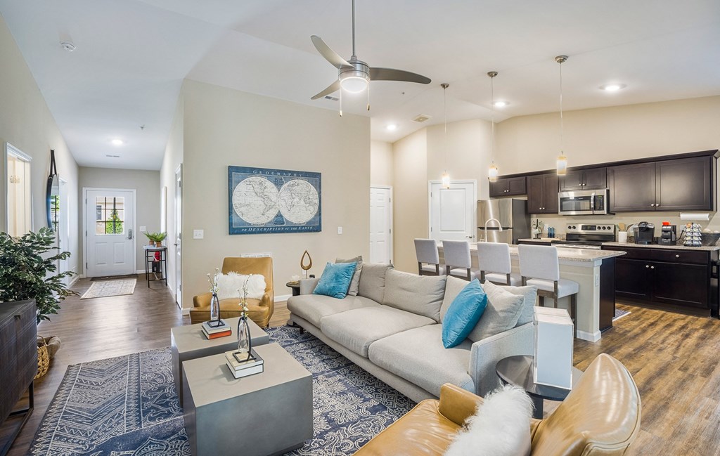 a living room and kitchen with a couch and a table
