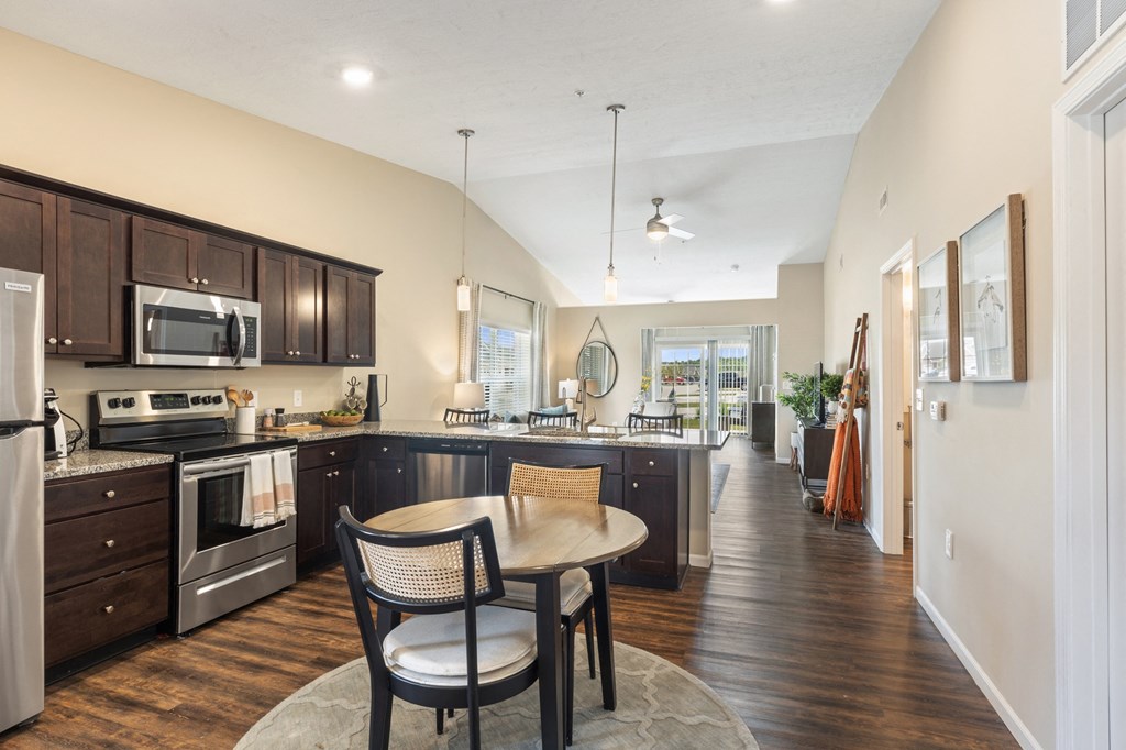an open kitchen and dining area with a table and chairs