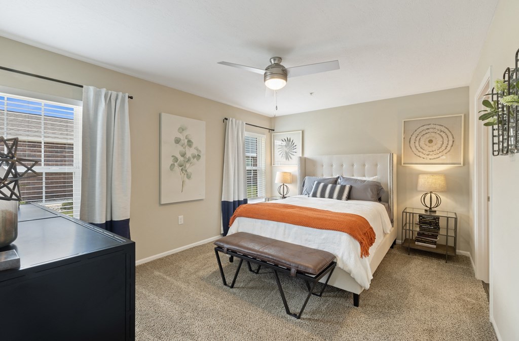 a bedroom with a bed and a ceiling fan