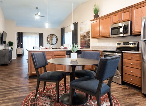 an open kitchen and dining area with a table and chairs