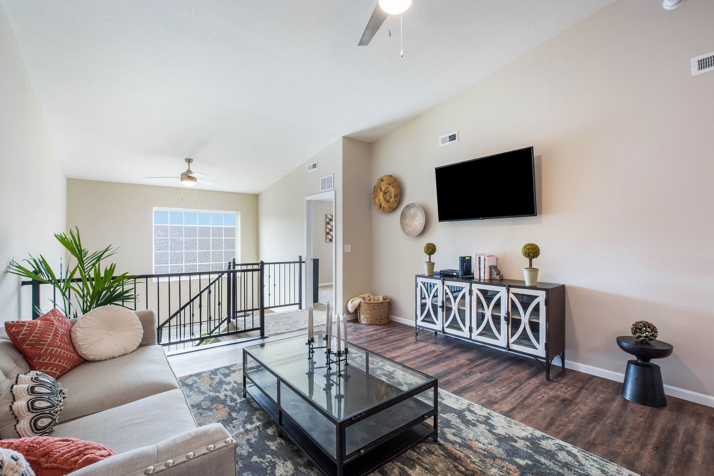 a living room with a couch and a glass table