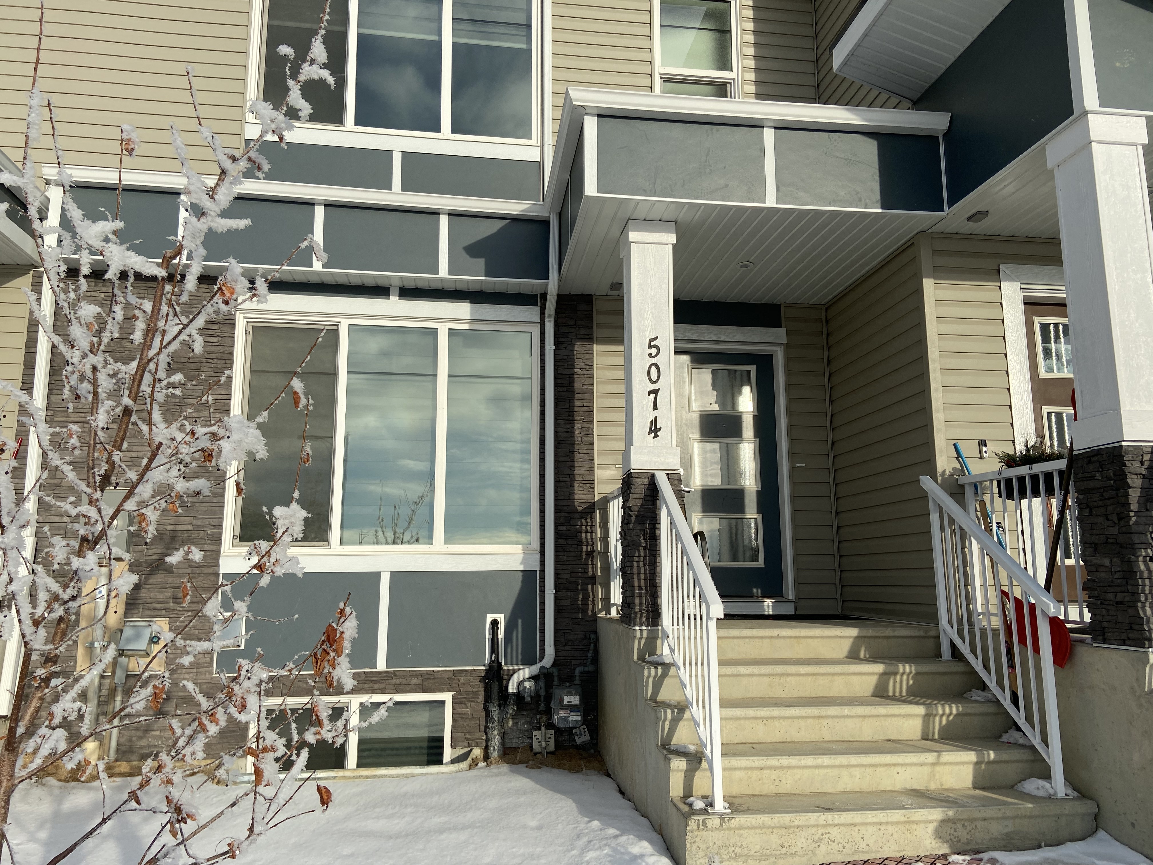 A house numbered 503 is shown with snow on the ground and a tree in front.