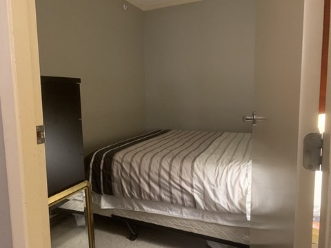 a bedroom with a bed and a wardrobe