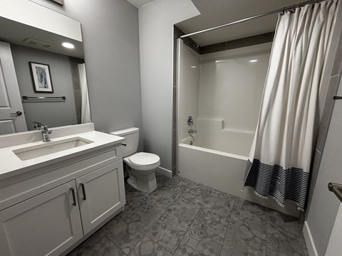 A bathroom with a toilet, sink, and bathtub.