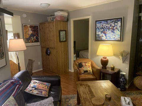 A living room with a couch, chair, and lamp.