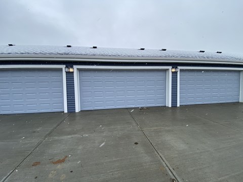 A building with three garage doors.