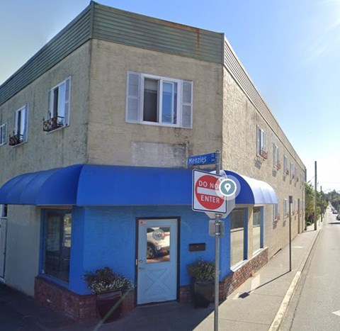 A blue and white building with a sign that says "Do Not Enter".