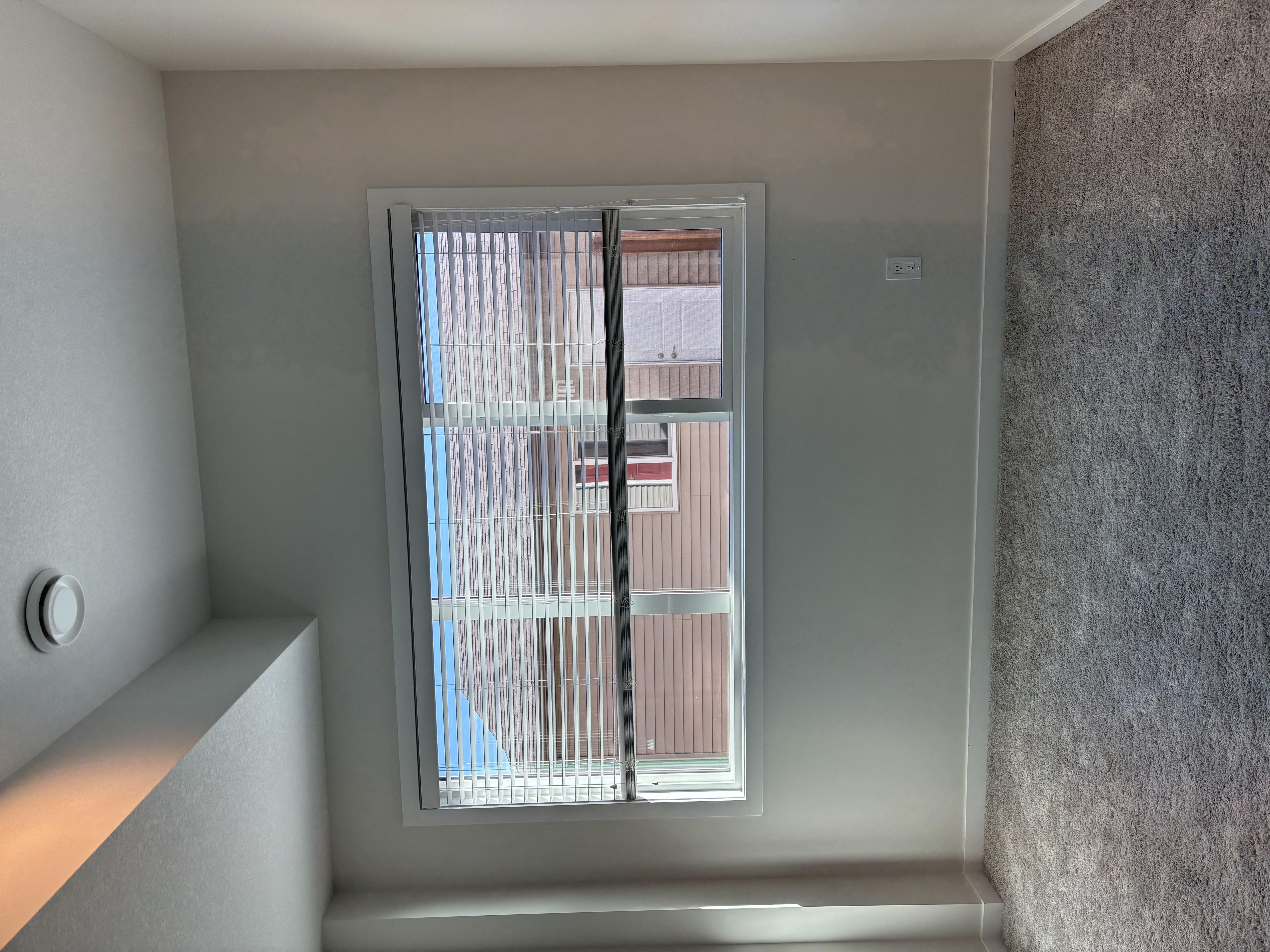 A window with a view of a building outside.