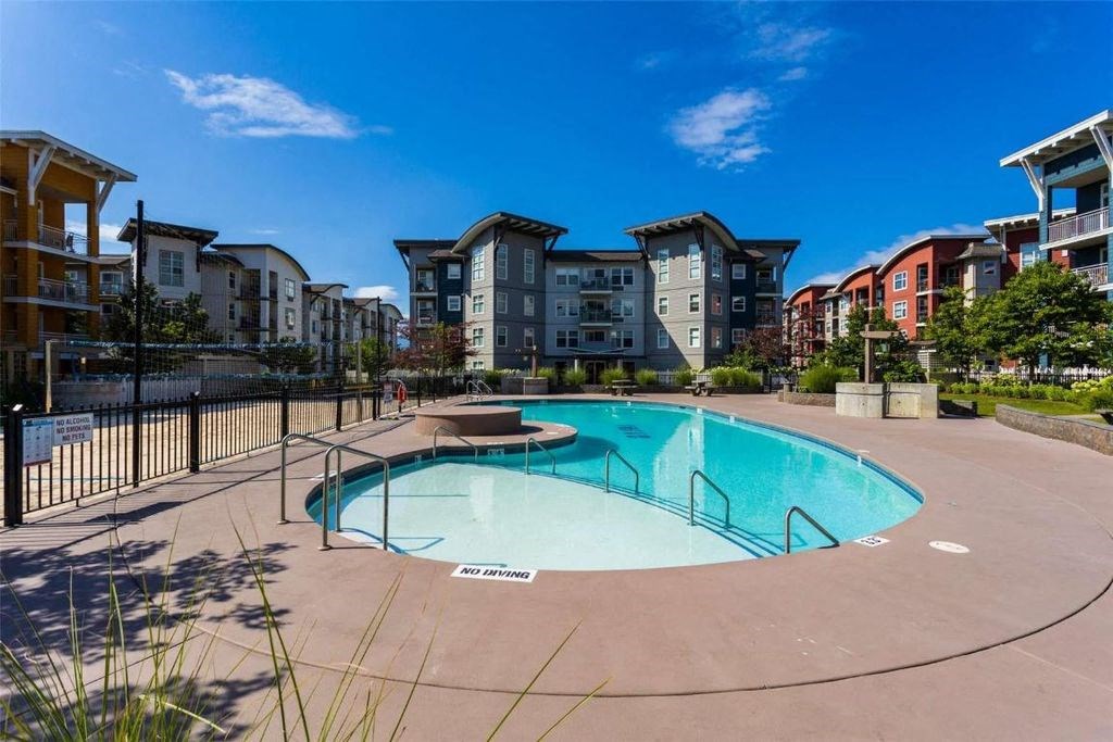 A swimming pool surrounded by apartment buildings.