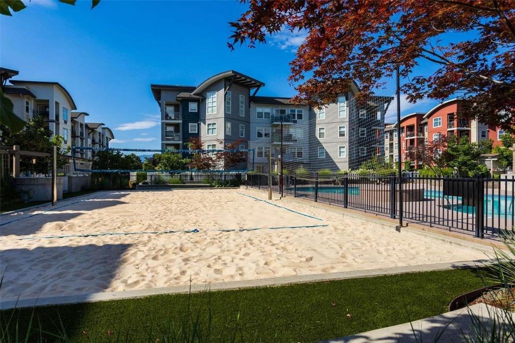 A sandy area in front of apartment buildings.