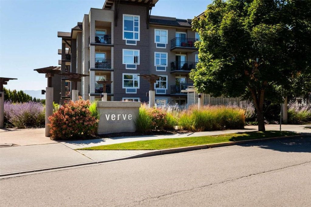 A modern apartment building named Verve is surrounded by greenery and landscaping.