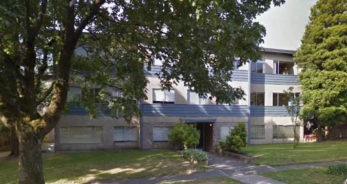 a large building with a tree in front of it