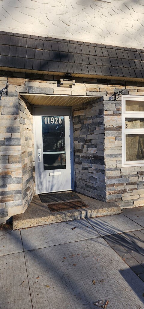 A house with a white door and a number 11928 on it.
