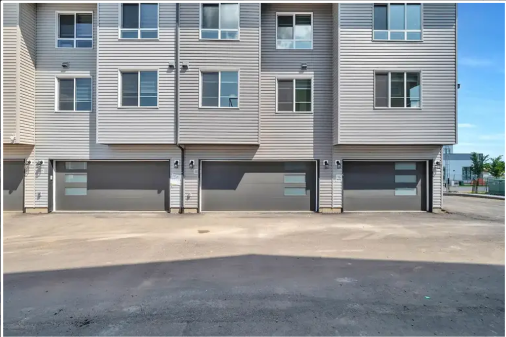 an empty parking lot in front of an apartment building