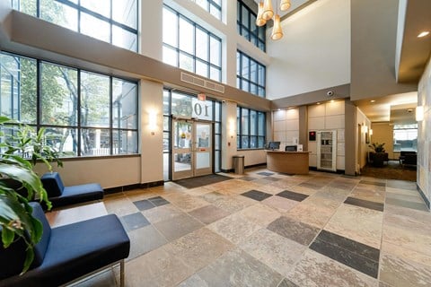 A reception area with a blue bench and a sign that says "01".