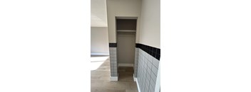 A bathroom with a shower stall and tiled walls.