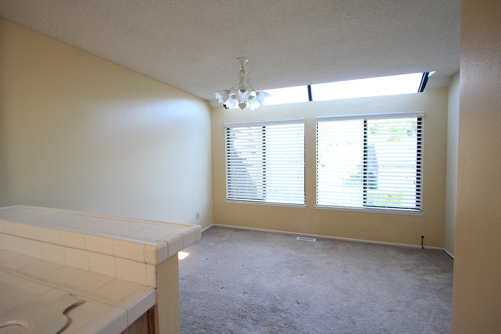 a bedroom with a large window and a white counter