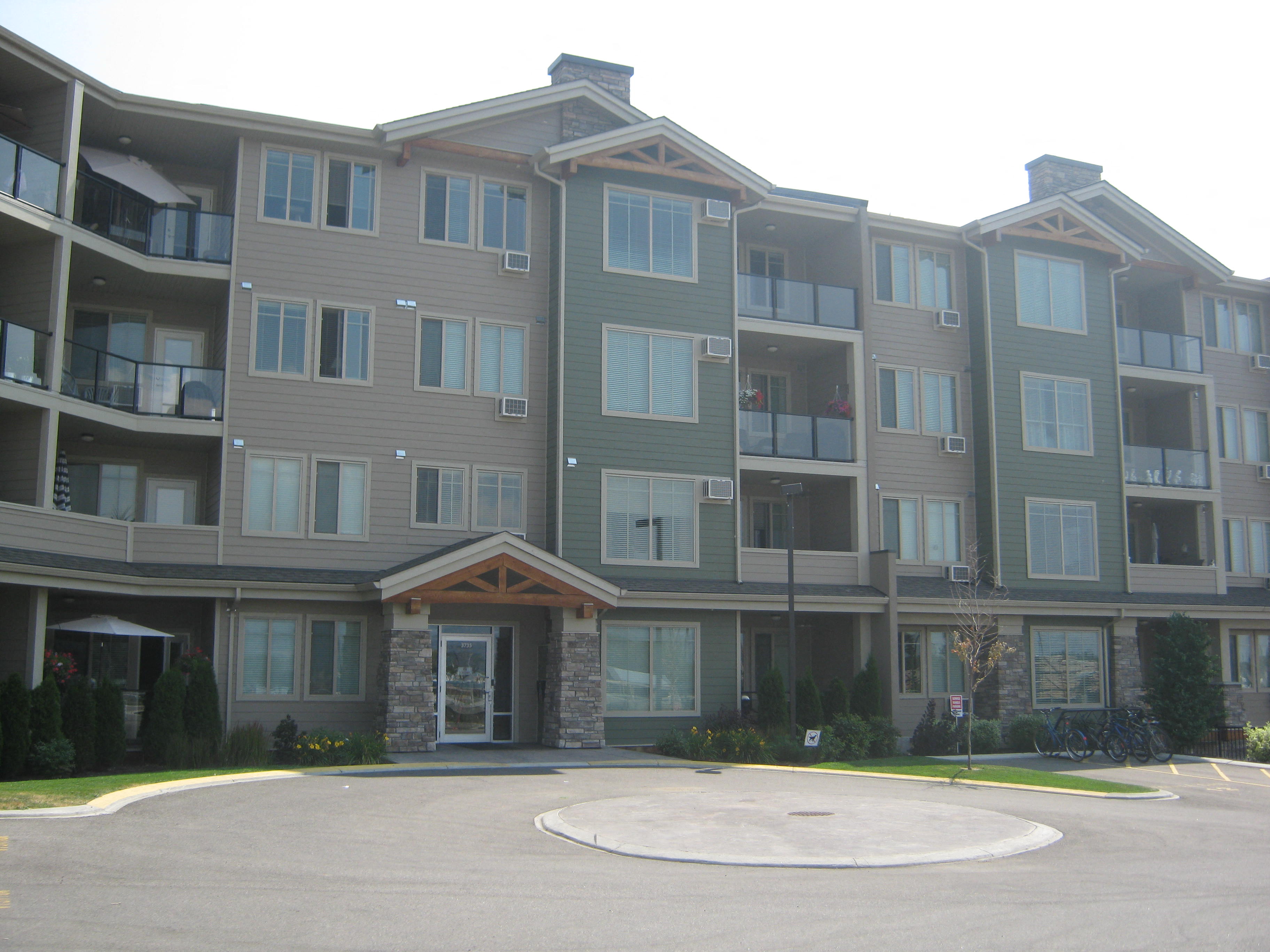 a large apartment building with a roundabout in front of it