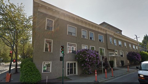 a building on the corner of a street with a traffic light