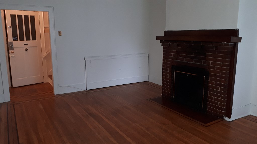 room in a large house with garden and fireplace