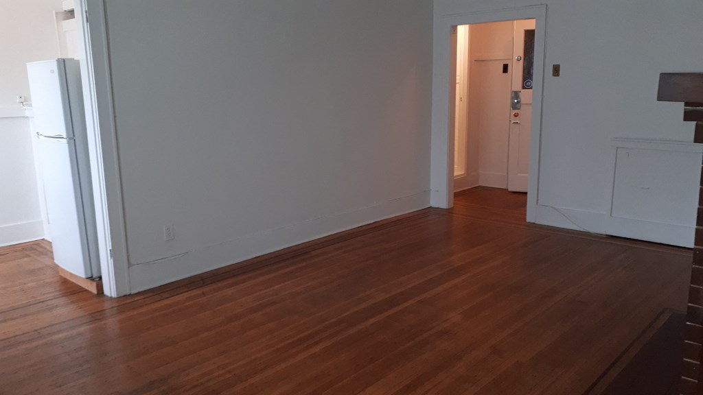 an open kitchen and dining room with hardwood floors