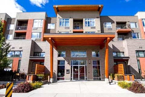 A modern building with a large front entrance and a balcony.