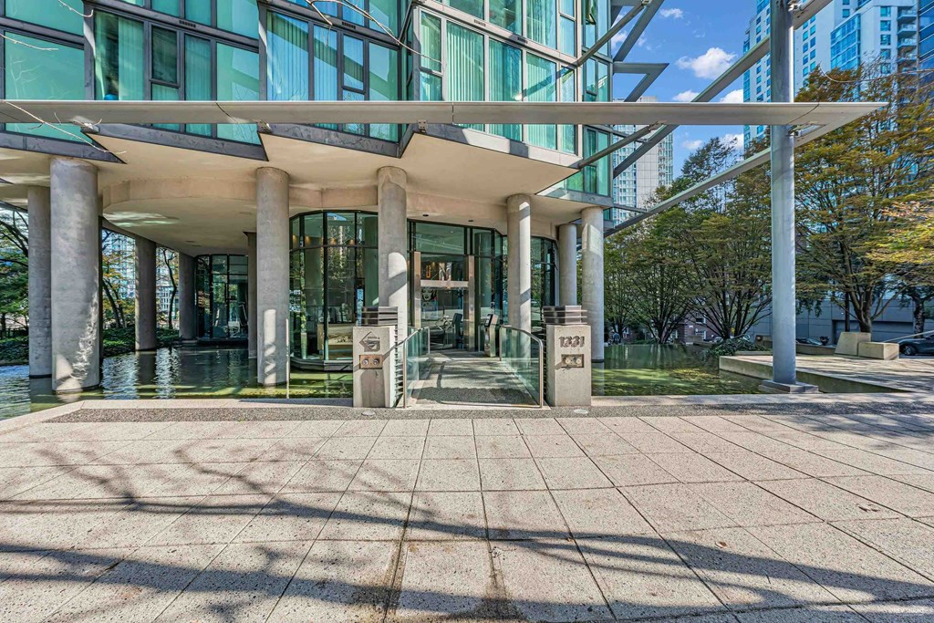 A modern building with glass windows and a white roof.