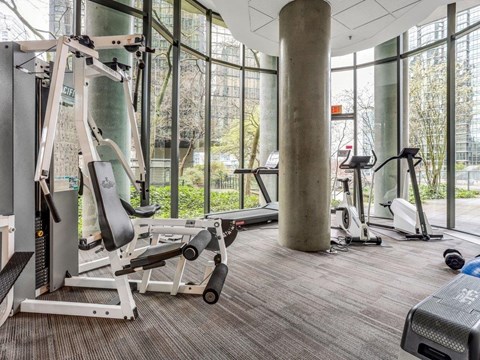 A gym with a variety of equipment including a leg press machine.