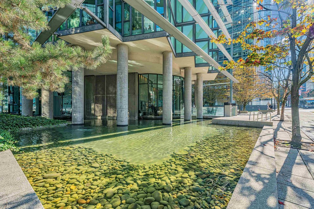 A modern building with a water feature in front.