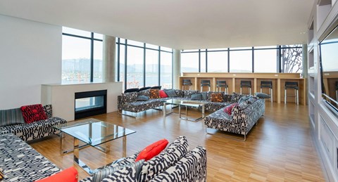 A living room with a fireplace and a zebra print couch.