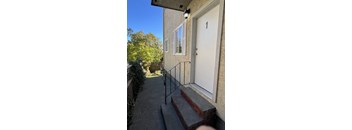 A white door with a number 1 on it is on the right side of a house.