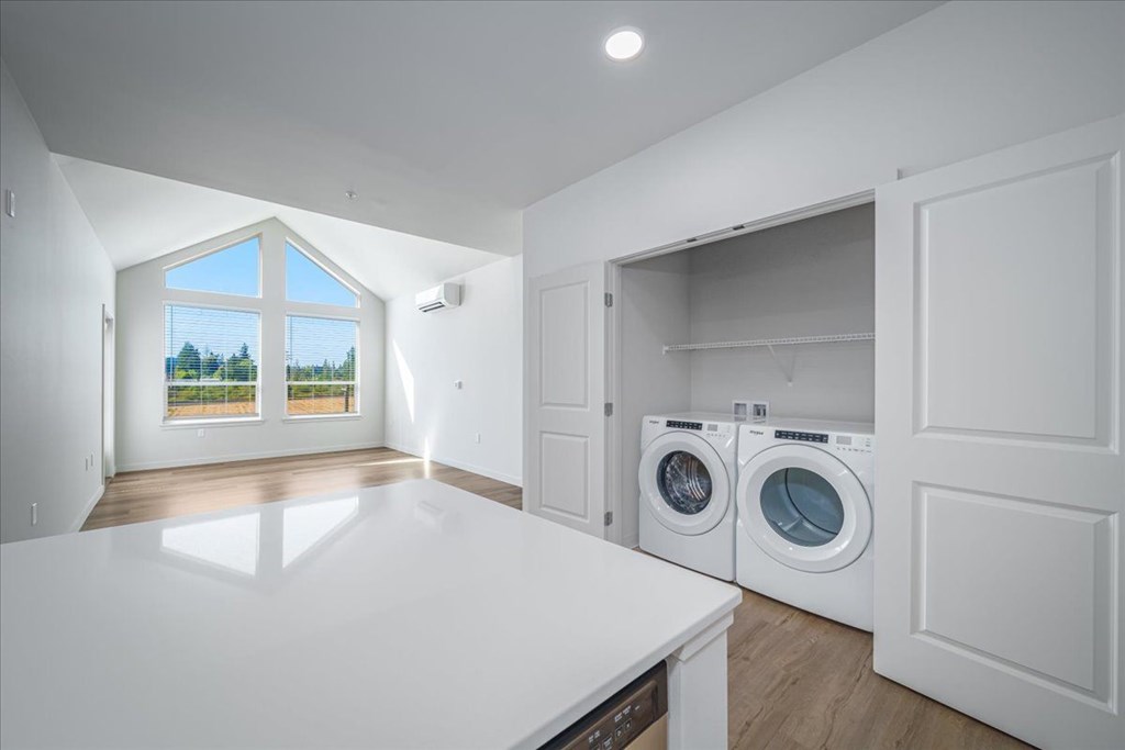 A laundry room with a washer and dryer in it.