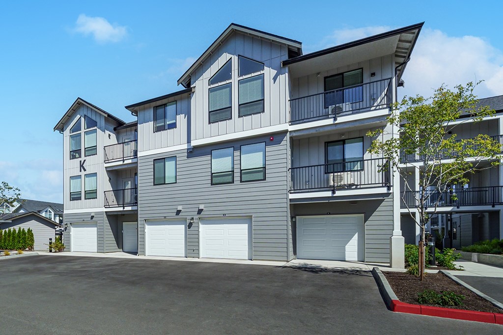 A modern two-story residential building with a garage.