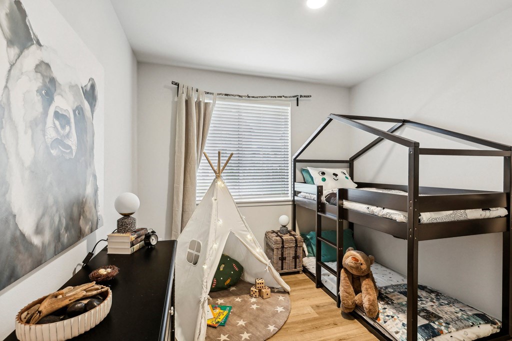 a childrens bedroom with bunk beds and a tent