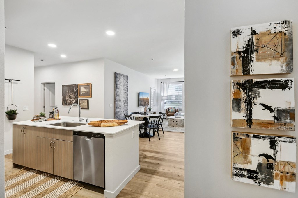 a kitchen with a sink and a counter top in a house