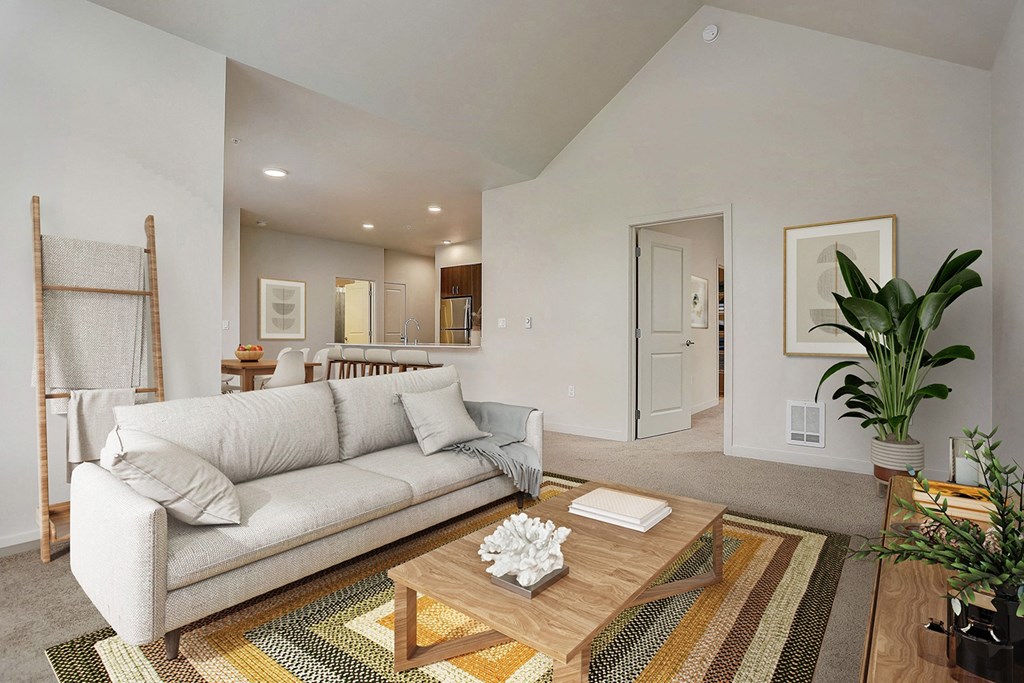 A living room with a white couch and a wooden coffee table.