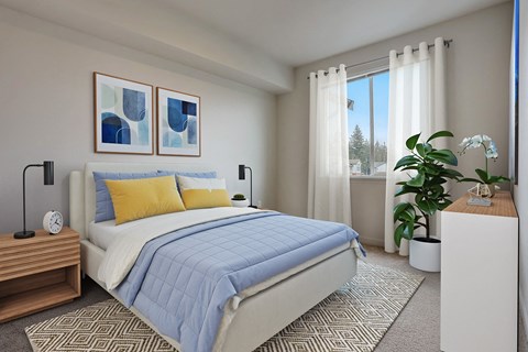 A bedroom with a large bed and a window with curtains.