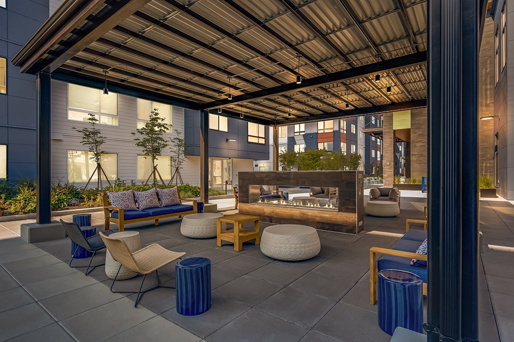 a rendering of a patio with furniture and a fire pit