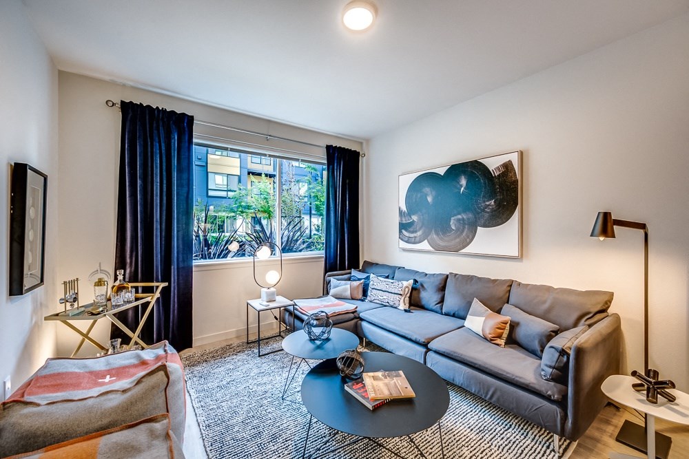 a living room with a couch coffee table and a large window