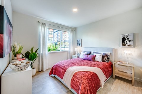 a bedroom with a bed and a window