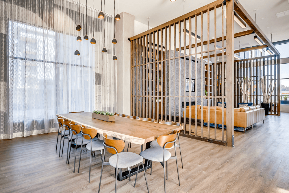 a dining room with a wooden table and chairs