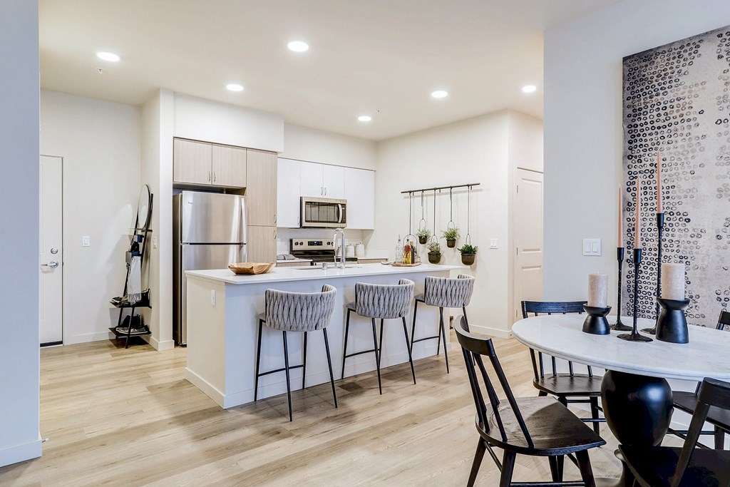 an open kitchen and dining area with a table and chairs