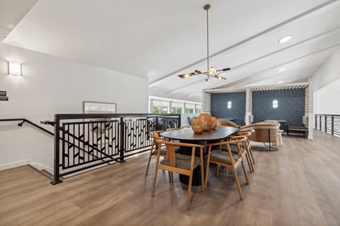 a dining room with a table and chairs and a balcony
