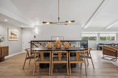 a dining room with a wooden table and chairs