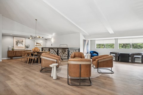 a living room with couches and chairs and a dining room table