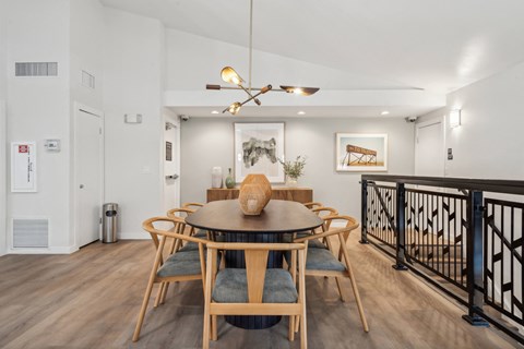 a dining room with a wooden table and chairs