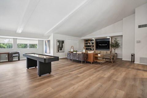 an open living room with a pool table and a tv